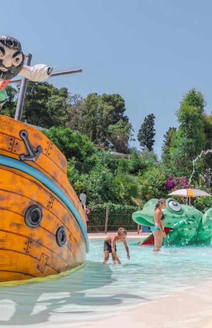 Parco acquatico con giochi per bambini e decorazioni colorate.